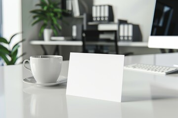 Fototapeta premium A blank card on a modern, minimalist desk with a computer and coffee mug. The clean, professional environment offers plenty of copy space for business-related messages.
