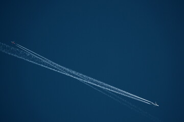 two planes in the sky, two airplane tracks in the blue sky, contrails