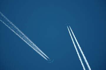 two planes in the sky, two airplane tracks in the blue sky, contrails