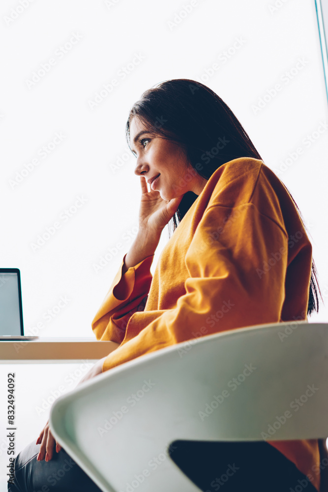 Poster below view of two skilled students having friendly conversation sitting at modern netbook with blank