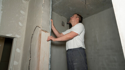 Mature man construction worker measuring