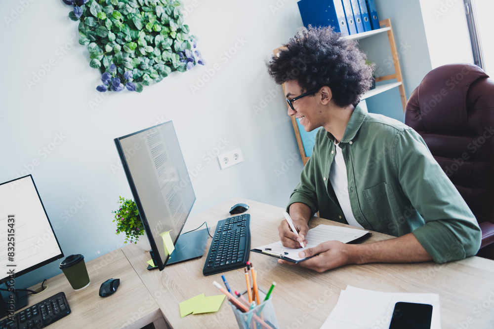 Canvas Prints photo of cheerful handsome agent dressed khaki shirt eyewear writing documents modern gadget indoors