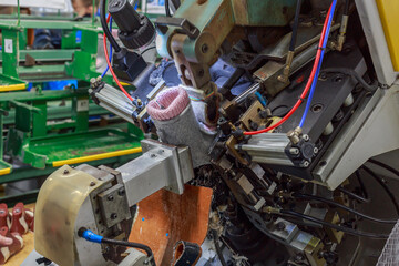 Closeup view of machine for stretching and attaching shoes.