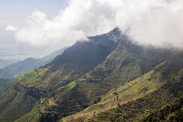 Amba Alaji in Ethiopia boasts a stunning landscape with majestic mountains, dramatic cliffs, and...