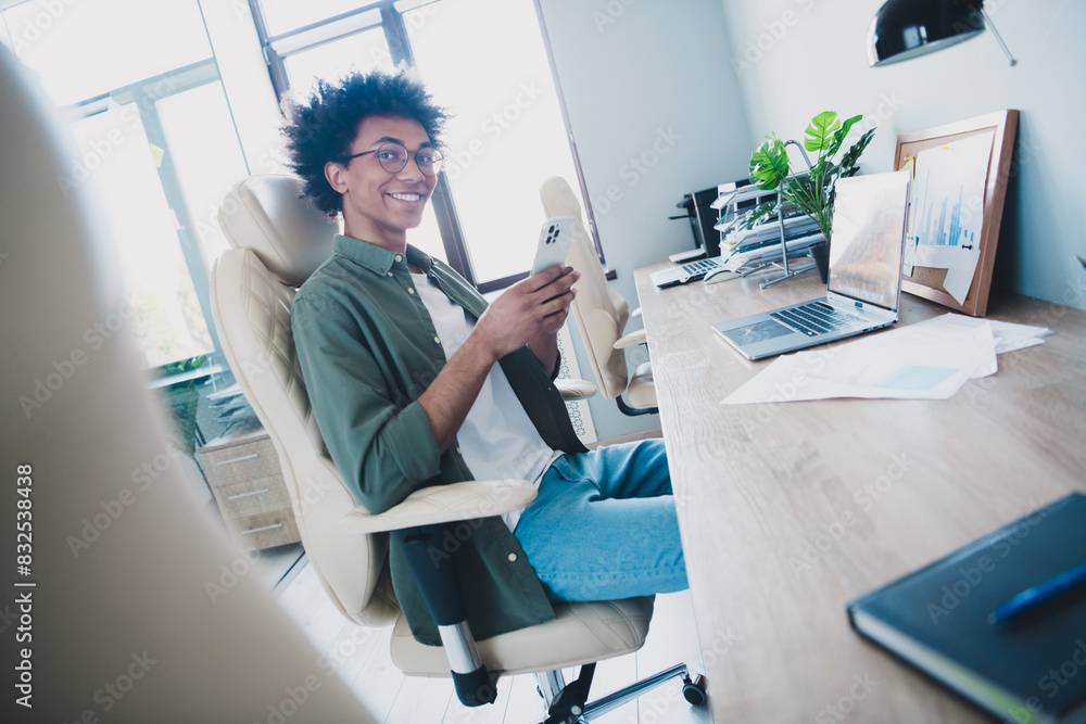 Sticker Photo of happy positive broker wear khaki shirt spectacles browsing modern device indoors workshop workstation