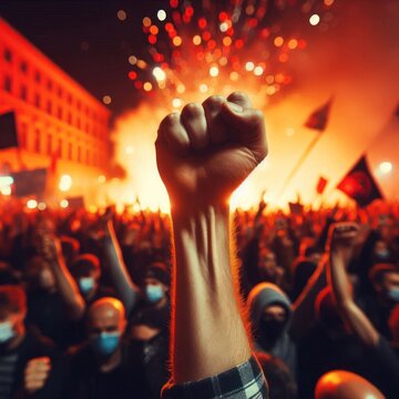 A raised fist of a protestor at a violent political demonstration