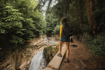 Woman hiking along the Taugl river in Tennengau, Austria.