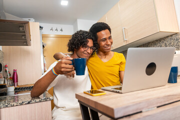 Gay couple drinking coffee during video call at home