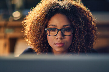 Black businesswoman, working and late night with glasses on computer in evening for work deadline....