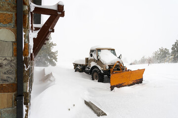 Snowstorm in Cheyenne Wyoming with unimog plow covered in snow