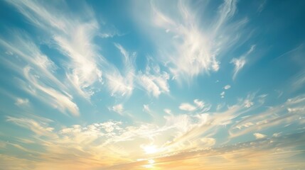 Fototapeta premium A serene sky with soft, wispy clouds, gently touched by the warm light of the late afternoon sun
