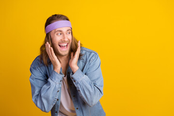 Photo portrait of attractive young hippie man raise hands look empty space wear trendy denim outfit...