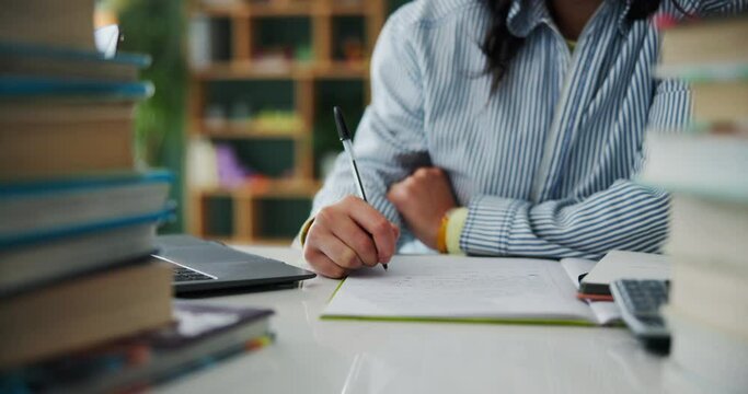 Hands, writing notes and student studying in home for college test, exam or research by laptop at desk. Journal, university and person learning for knowledge, creative education or to do list in book