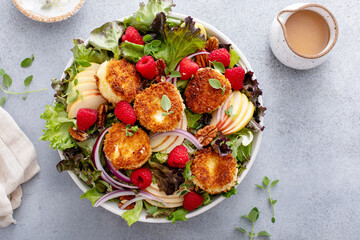 Fresh goat cheese salad with mixed greens and berries