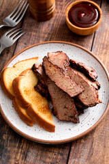 Juicy smoked brisket slices with toast on plate