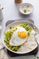 Fresh sauteed leafy greens with rice and topped with fried egg