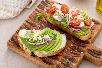 Fresh avocado toasts on wooden board