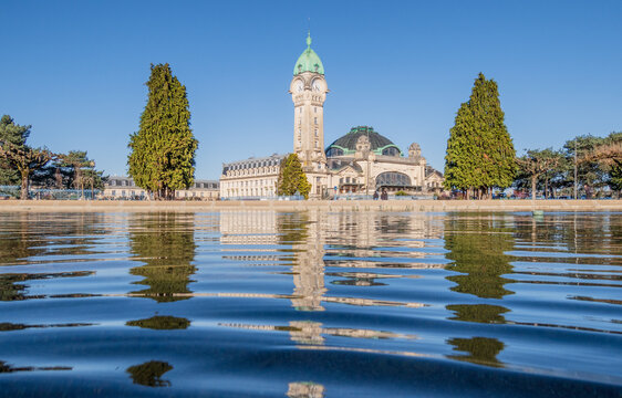 View of the train station in Limoges reflecting in blue water, France