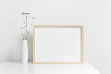 Blank landscape art frame mockup in white interior with stylish botanical decor, copy space