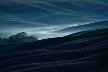 Field waves with fog, landscape in Tuscany, near the Siana and Pienza. Sunrise morning in Italy....