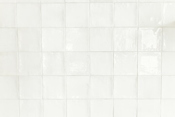 Modern tiles background. Installed white square rustic tiles wall close up in new scandinavian...