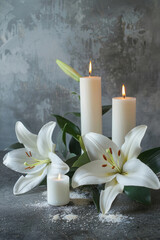 white lily and candles on a gray background