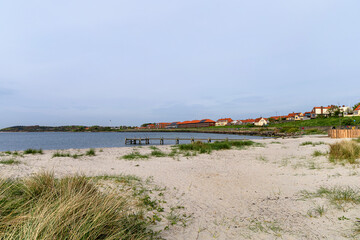  Natural beach with sand and grass in the town of Ronne on the Bornholm Island, Denmark