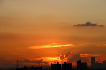Fototapeta premium orange blue skyscape background with cloud and city town building in evening of the day sunset twilight dusk time