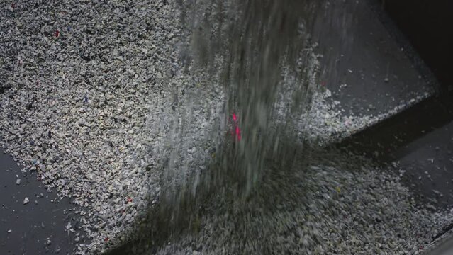Plastic particles fall onto a conveyor belt, scanned by a laser. Recycling of waste and garbage. Raw material or makes plastic granules for Polyethylene products. Garbage factory or waste plant