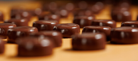 Banner Chocolate production factory. Sweets candy on industry conveyor. Process cocoa glazing
