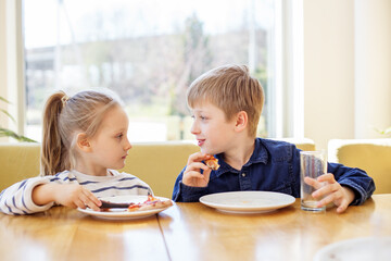 Children Conversing While Eating Pizza at Table