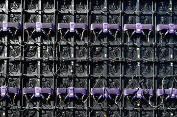 Back of wired televisions, TV sets or screens with various plugs and cables, as a background