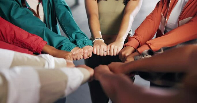 Hands, huddle and solidarity with group of people closeup for strength, support or unity from above. Circle, fist and trust with friends together for community, mission or team building closeup