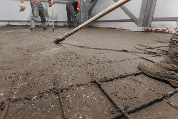 Construction site of buildings pouring cement. Top view new screed concrete with leveling mortar for floors