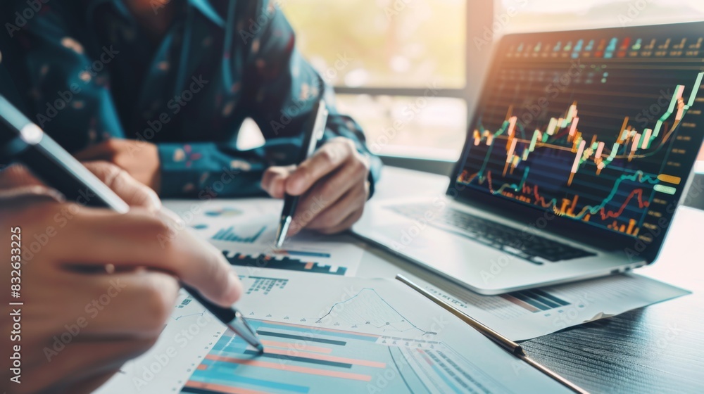 Poster a financial planner reviewing stock market performance with a client while pointing to a stock marke