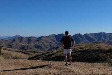 Fototapeta premium Man admiring the Namib Desert, Africa Namibia