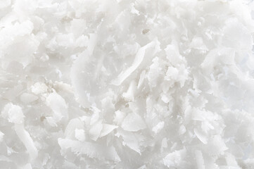 Fresh coconut flakes on white background, top view. Close-up