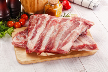 Raw pork ribs over board