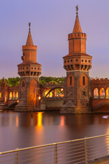 Old Berlin Oberbaum Bridge over the Spree River at sunset.