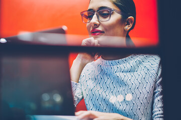 Positive businesswoman preparing for video conference using application on laptop computer sitting...