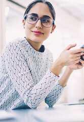 Skilled female employee using portable pc for checking mail and updating content of web site...