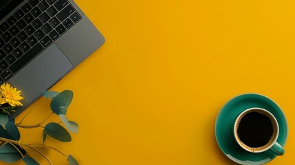 Sleek Black Laptop and Green Coffee Cup on Vibrant Yellow Background. Copy space