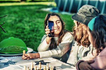 Group of young children playing at table board games.