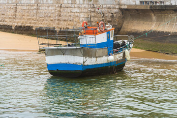 Cascais beach near Lisbon in Portugal. Cloudy day, empty beach, some fishermen's boats