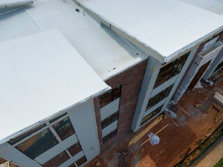 Fototapeta premium Drone Images of Commercial Building Roofs. TPO, Dome, Flat, White