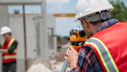 Civil or construction engineer using a survey camera, or an engineer with an auto level camera.