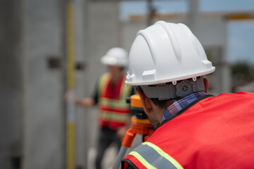 Civil or construction engineer using a survey camera, or an engineer with an auto level camera.