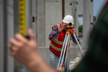 Civil or construction engineer using a survey camera, or an engineer with an auto level camera.
