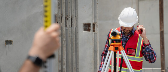Civil or construction engineer using a survey camera, or an engineer with an auto level camera.
