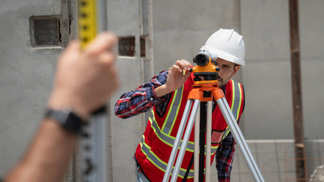 Civil or construction engineer using a survey camera, or an engineer with an auto level camera.